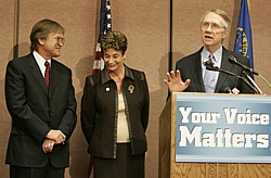Bob Loux, left, and Rep. Shelley Berkley listen as Nevada Sen. Harry Reid speaks at a news conference on Yucca Mountain in 2006. Reid says Louxs entire career should be weighed as his fate is decided